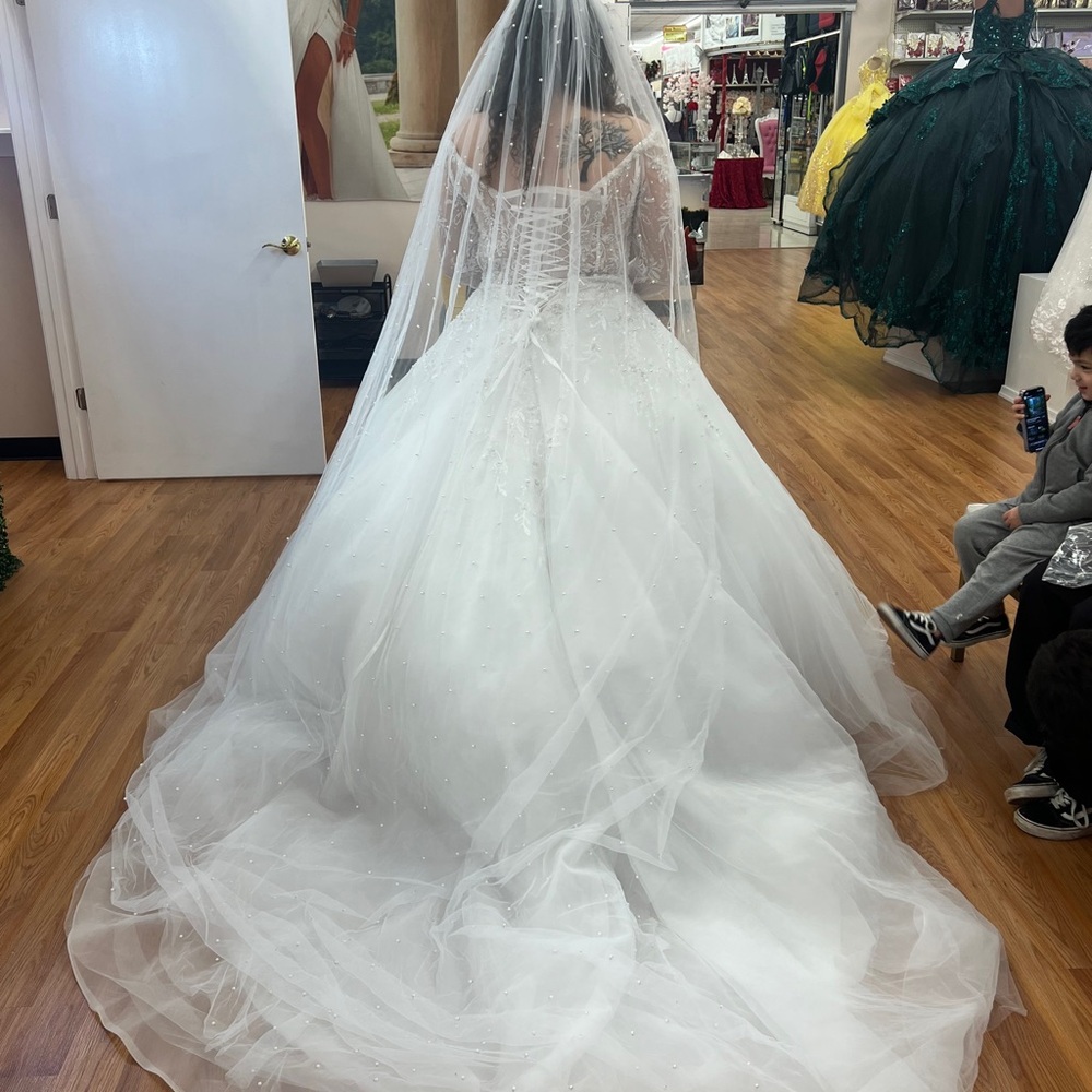 Elegant White Wedding Gown with Beaded Details